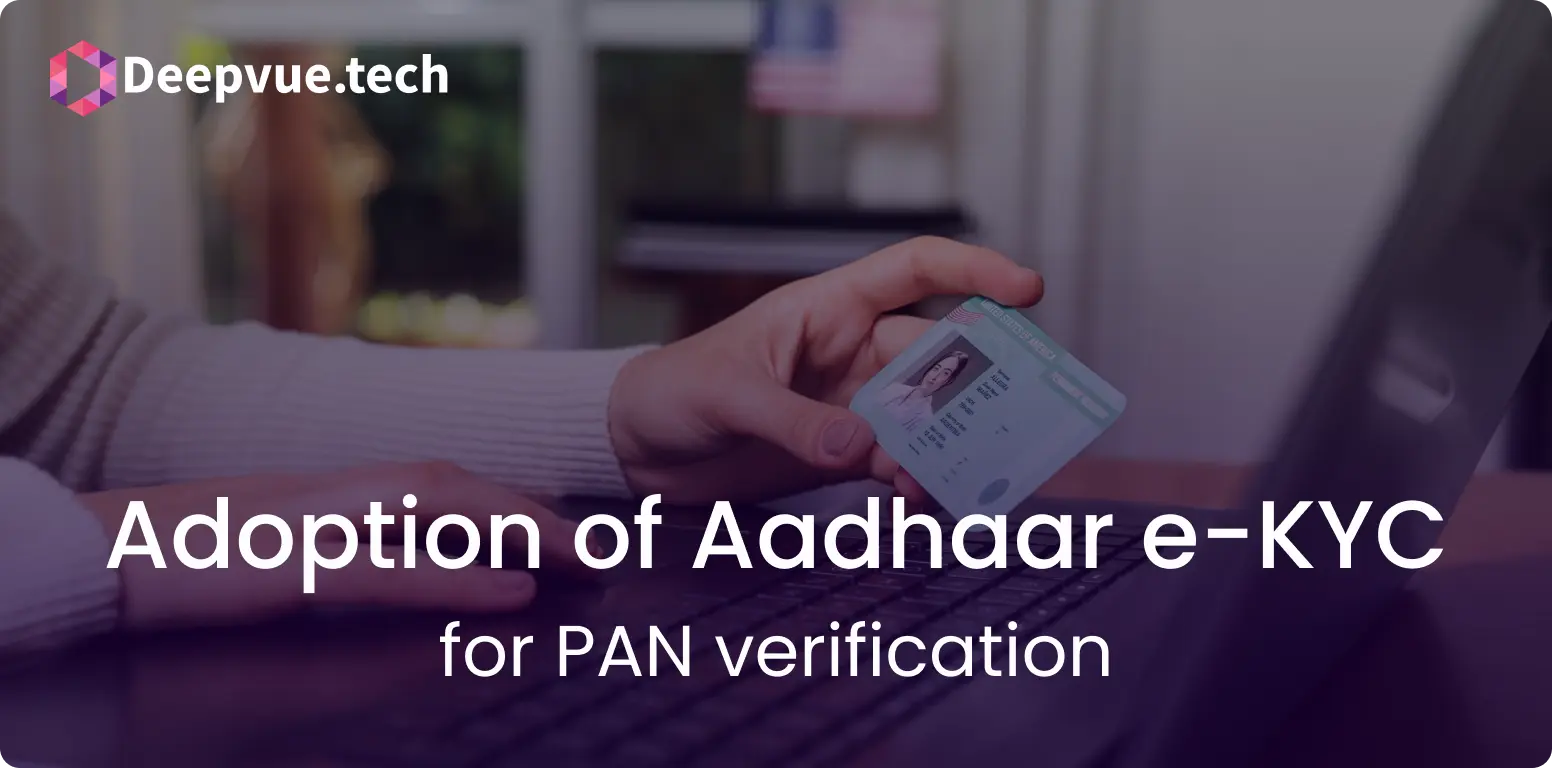 A person holds a card in one hand while typing on a laptop. Text overlay reads "Adoption of Aadhaar e-KYC for PAN verification".