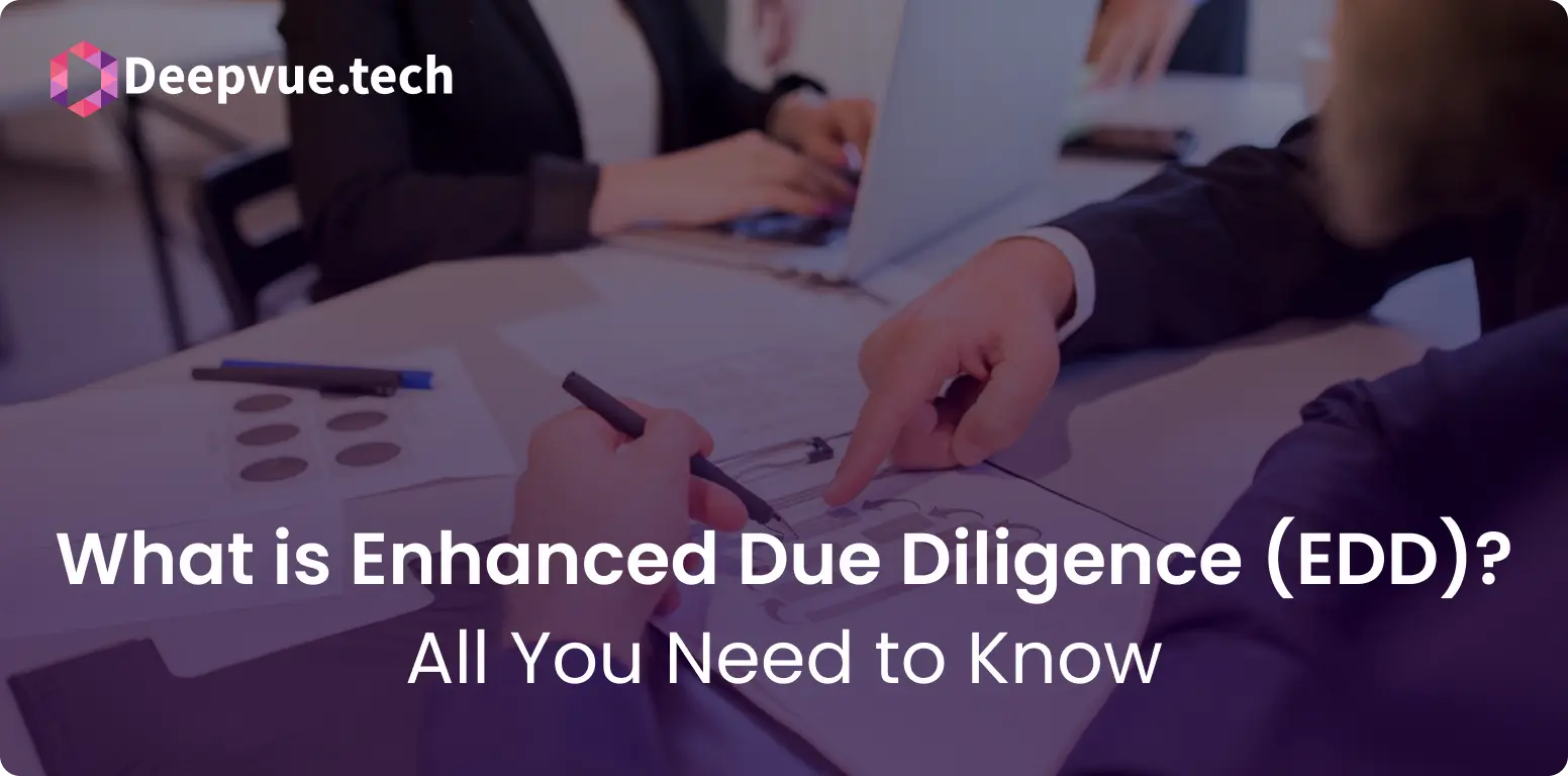 Two people are engaged in a business discussion at a table, pointing at a document. The image is overlaid with the text, "What is Enhanced Due Diligence (EDD)? All You Need to Know," branded by Deepvue.tech.