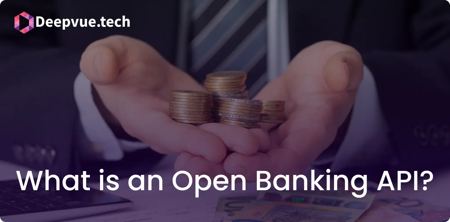A person in a suit holds a stack of coins in both hands. Text reads, "What is an Open Banking API?" with the Deepvue.tech logo in the top left corner.